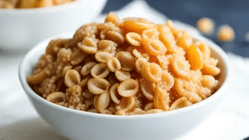 A bowl of cooked pasta shells and couscous.